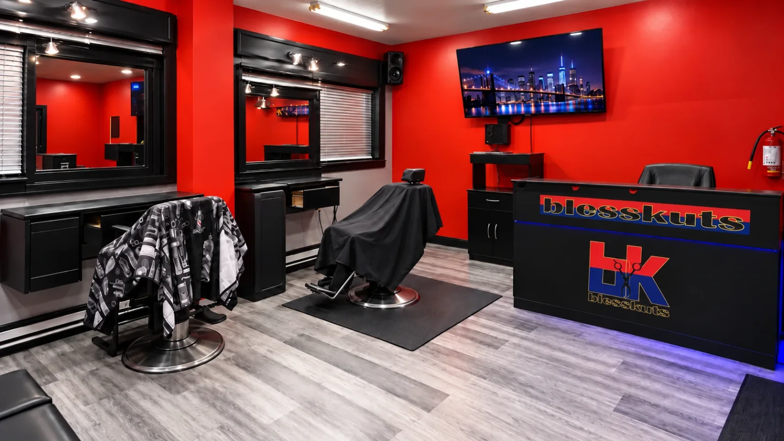 Inside BlessKuts: red walls, the barber chair, mirrors and the BlessKuts front desk