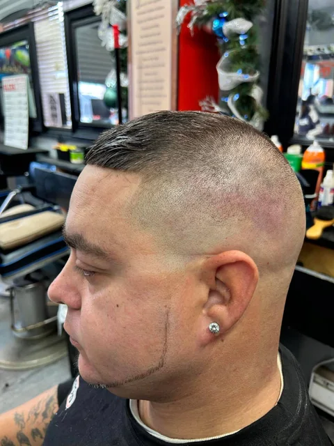 High skin fade with a slicked-back top and sharp lineup