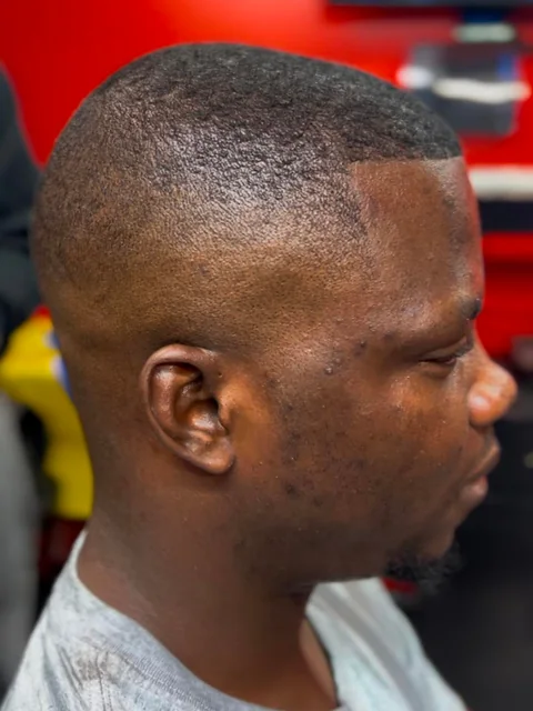 Short buzz cut with a clean taper and lineup