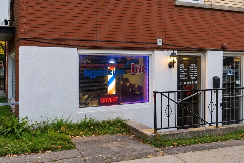 The BlessKuts storefront: shop window with barber pole and Ouvert sign, entrance with opening hours